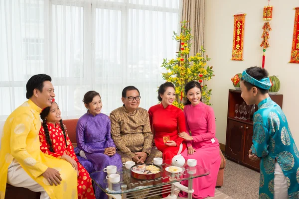 Boy  performing in front of family — Stock Photo, Image