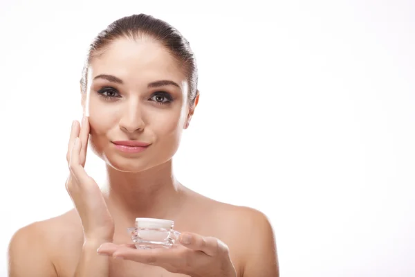 Woman applying moisturizer — Stock Photo, Image