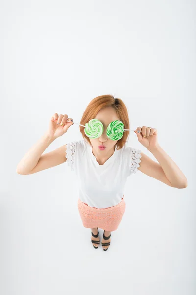 Girl covering her eyes with sugarplums — Stock Photo, Image