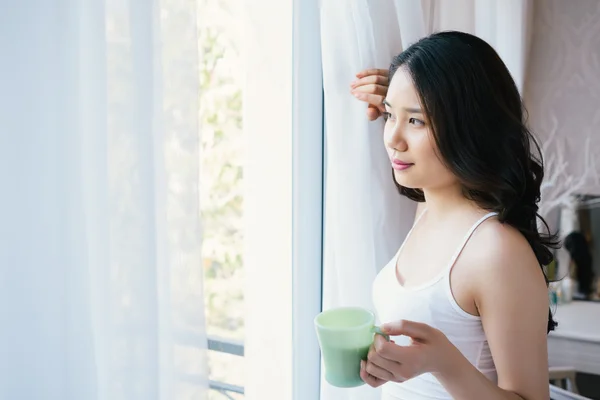 Pensive  woman with a cup of coffee — Stock Photo, Image