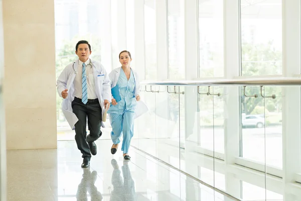 Medico e infermiera in esecuzione nel corridoio — Foto Stock