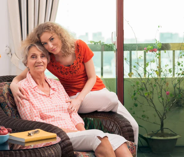 Granddaughter hugging grandmother — Stock Photo, Image