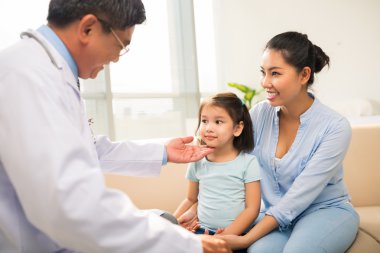 Girl and mother visiting pediatrician clipart