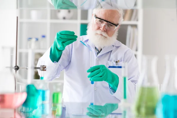 Scientist filling test-tube — Stock Photo, Image