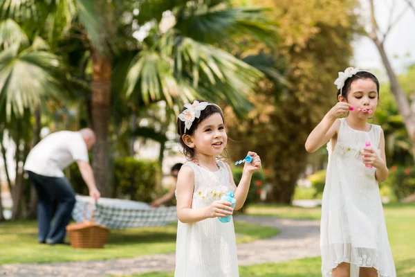 Girls playing with soap bubbles — Stock Photo, Image