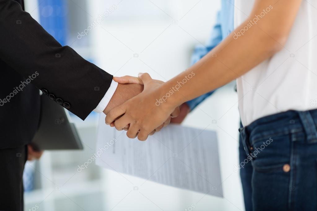 financial adviser and client shaking hands