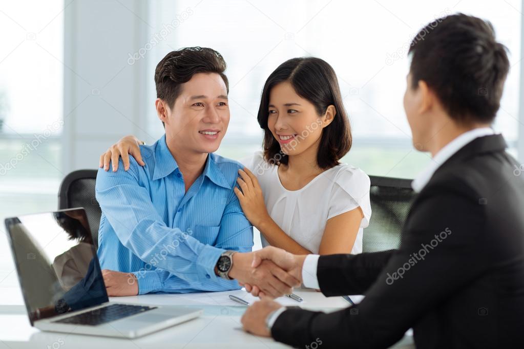 shaking hands with real estate broker