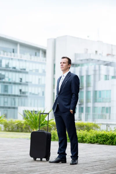 Pensive businessman with a suitcase — Stock Photo, Image