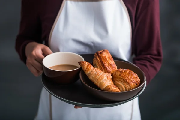 Waiter  with croissants and coffee — Stock Photo, Image