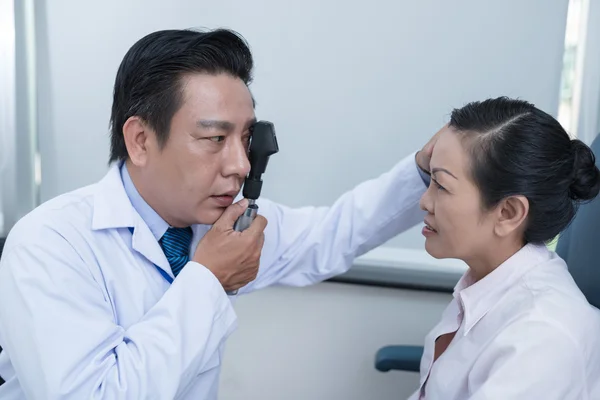 Optometrista usando oftalmoscopio — Foto de Stock