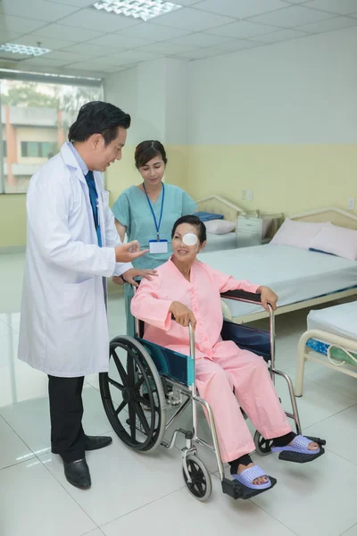 Mujer en silla de ruedas hablando con el médico —  Fotos de Stock