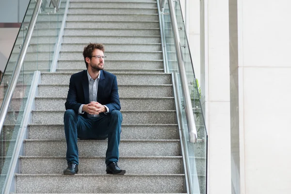 Businessman sitting on stairs — Stock Photo, Image