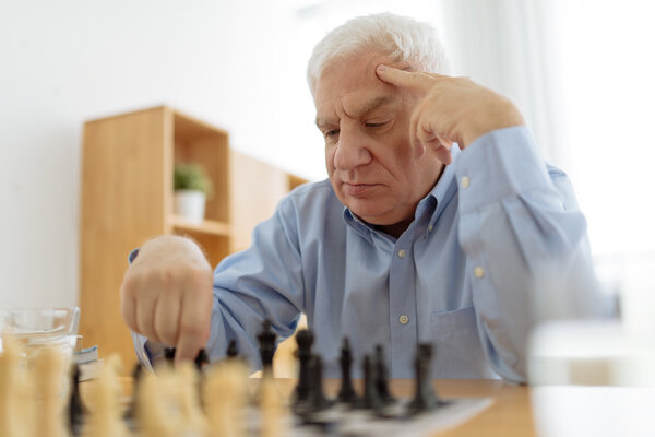 man thinking over his move in chess