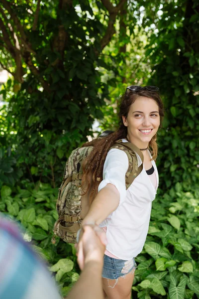 Female backpacker taking hand of her boyfriend — Stock Photo, Image