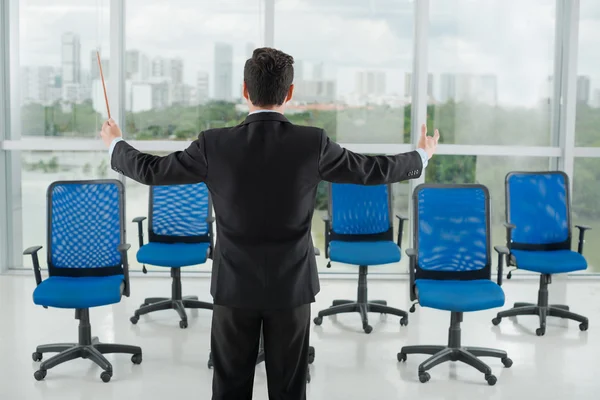 Businessman conducting his invisible employees — Stock Photo, Image