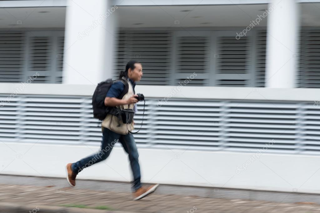 photographer running in the street