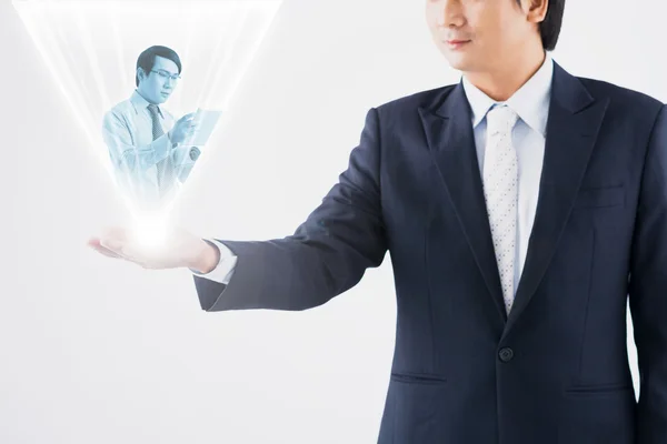 Businessman holding hologram projection — Stock Photo, Image