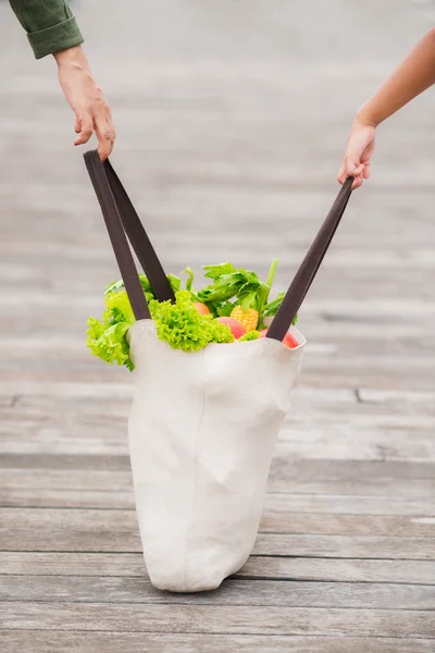 Carrying shopping bag full of groceries — Stock Photo, Image