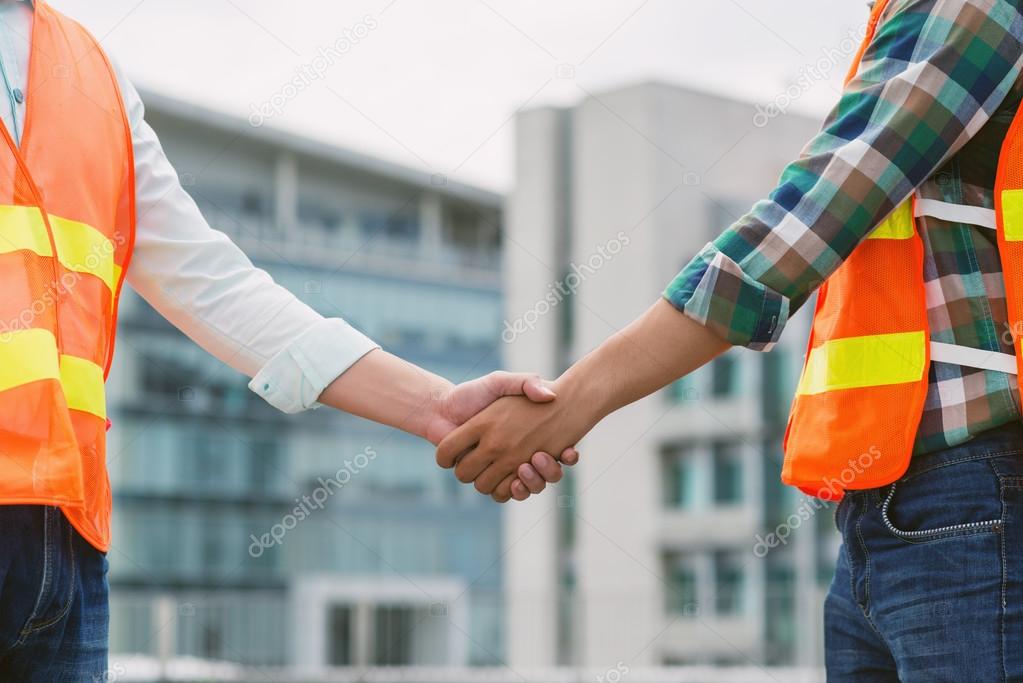 contractor and worker shaking hands