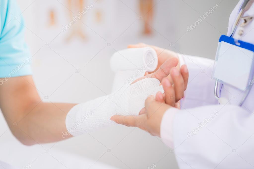 Doctor bandaging wrist