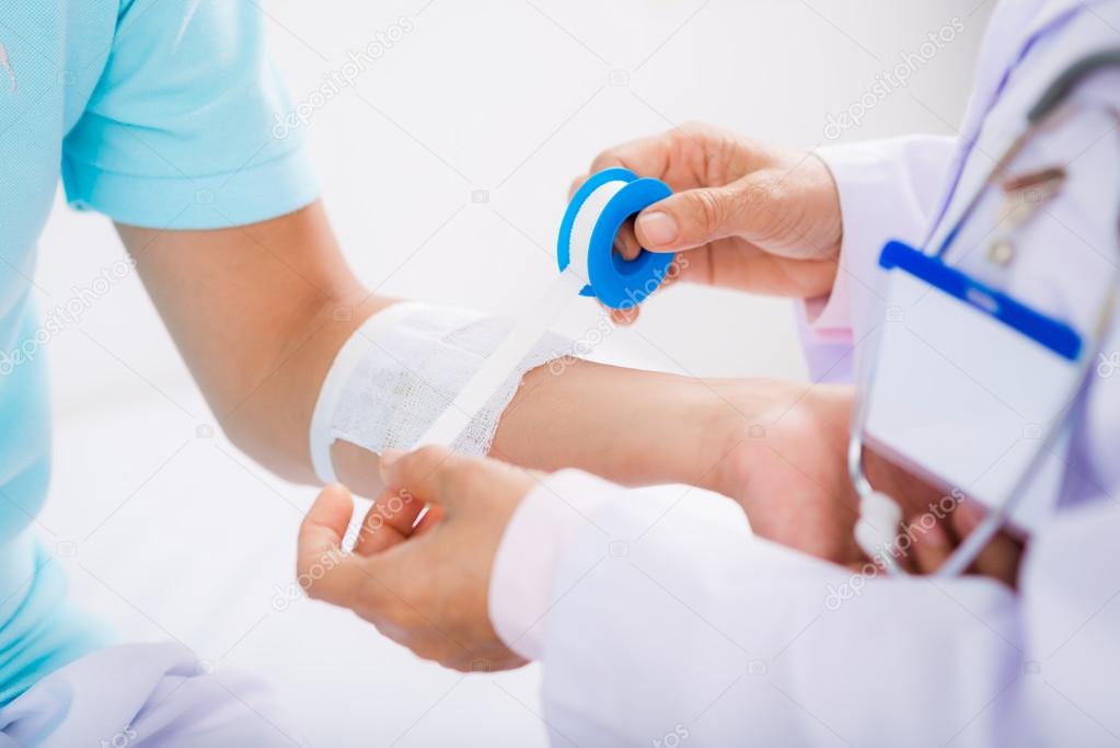 man having arm bandaging