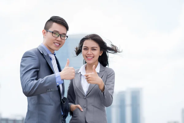 Business colleagues showing thumbs up — Stock Photo, Image