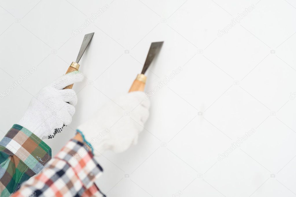 Hands of two workers plastering a wall