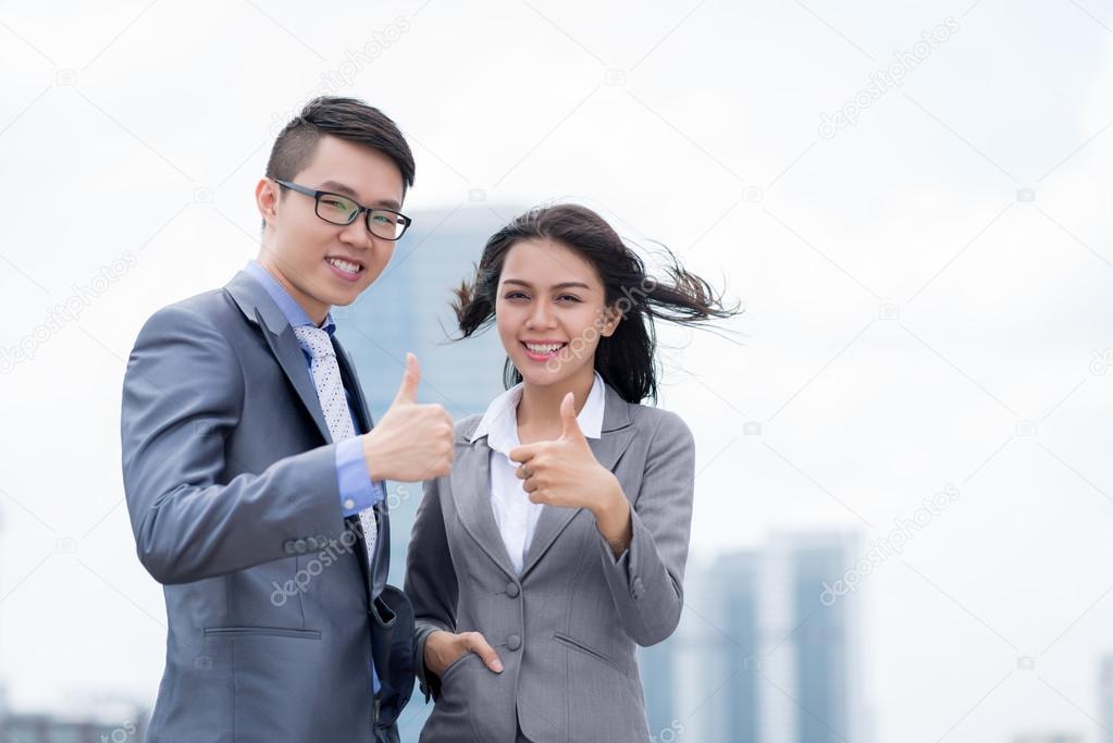 business colleagues showing thumbs up