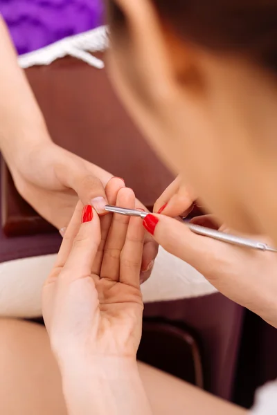 Manicurist using steel cuticle pusher — Stock Photo, Image