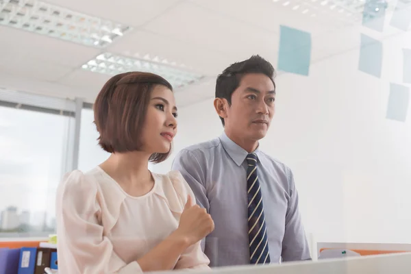 Compañeros de trabajo mirando pegatinas memo — Foto de Stock