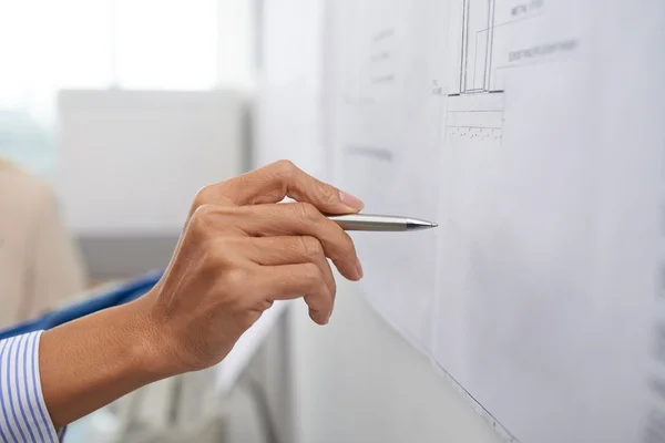 Hand with pen pointing at the blueprint — Stock Photo, Image