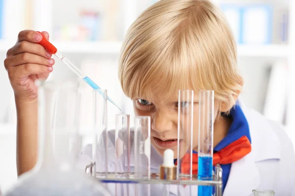 Schoolchild filling test tubes — Stock Photo, Image