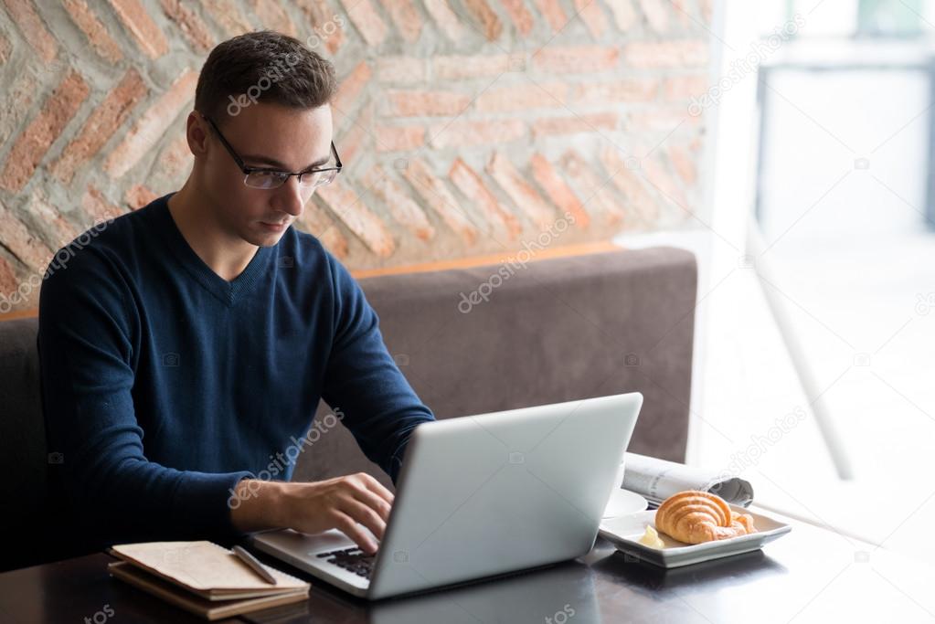 programmer coding in a cafe