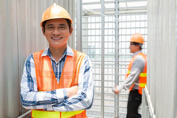 Asian engineer in orange vest — Stock Photo, Image