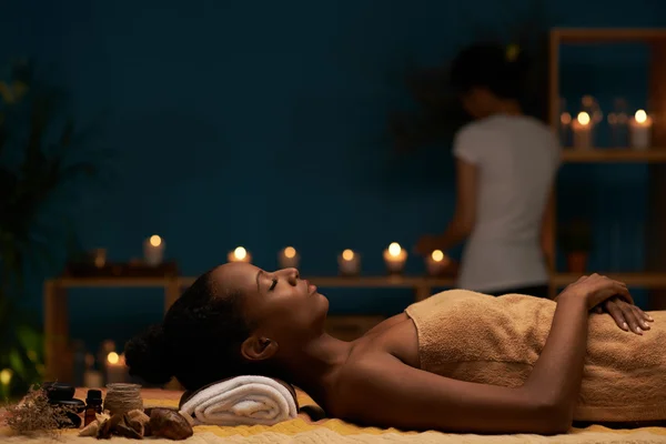 Mulher relaxante na mesa de massagem — Fotografia de Stock