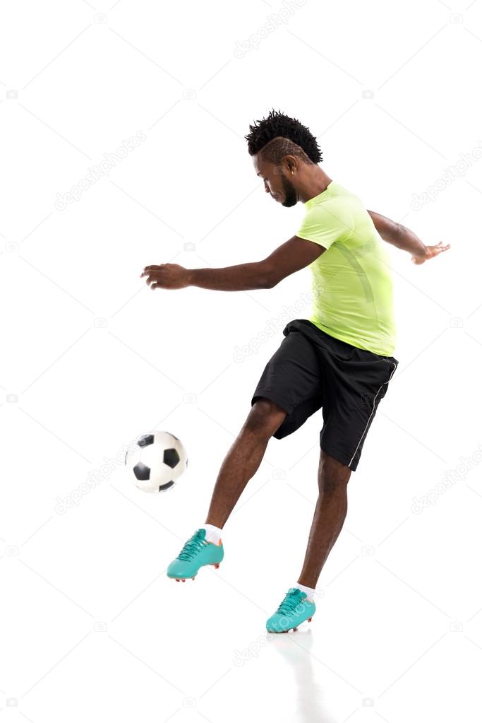 Professional player kicking soccer ball