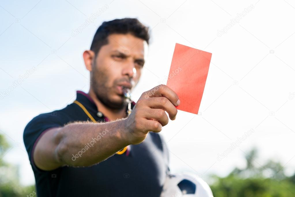 Soccer referee showing penalty card