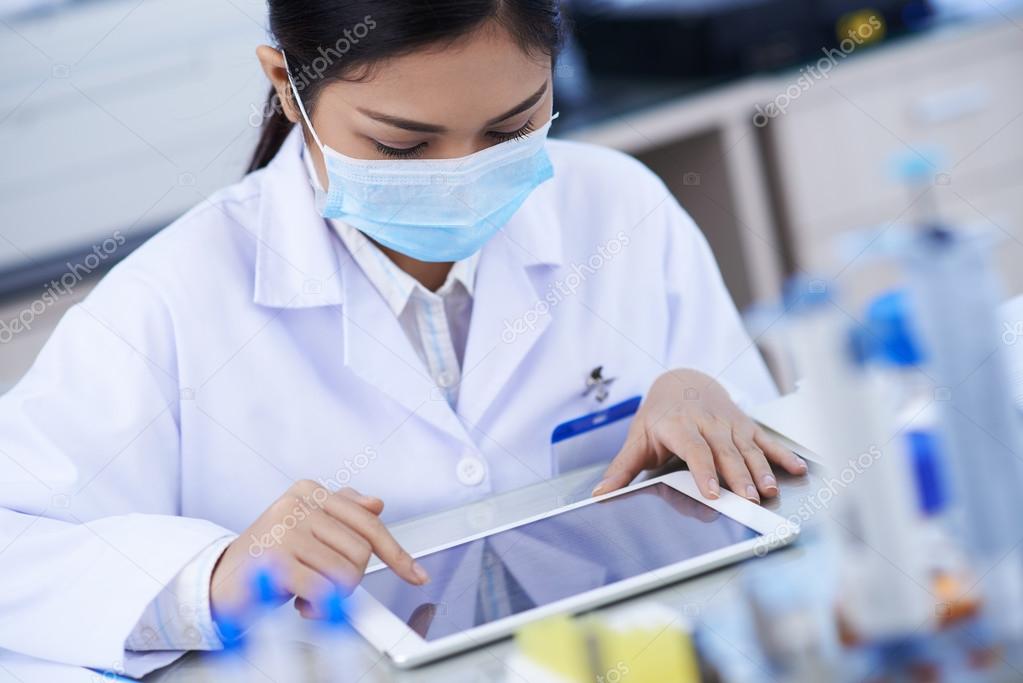 Laboratory worker using digital tablet