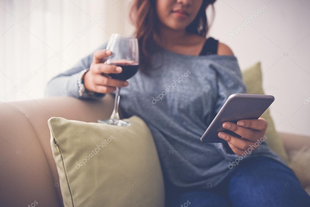 Woman with wine and smartphone
