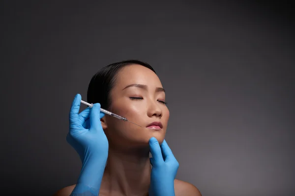Face of woman getting injection — Stock Photo, Image