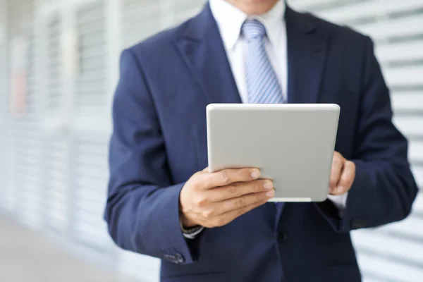 Businessman with touchpad in hands — Stock Photo, Image