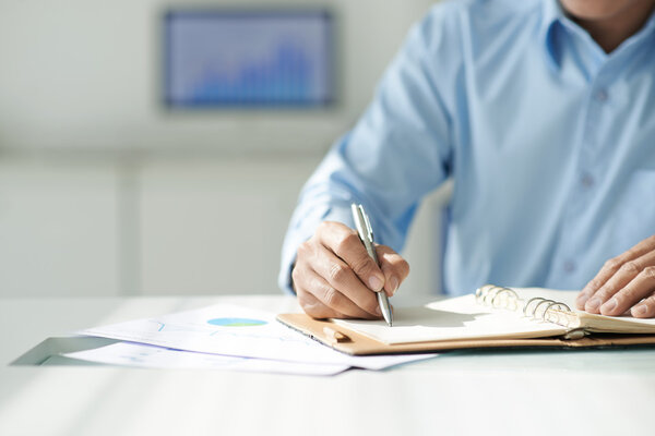 Businessman checking his personal organizer