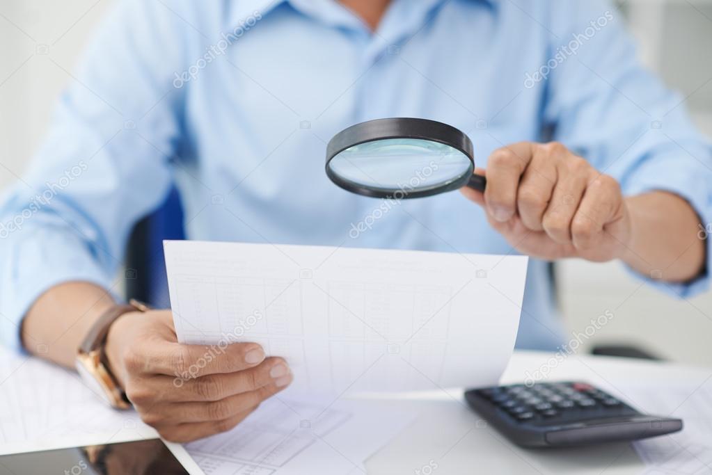 Financial adviser with magnifying glass