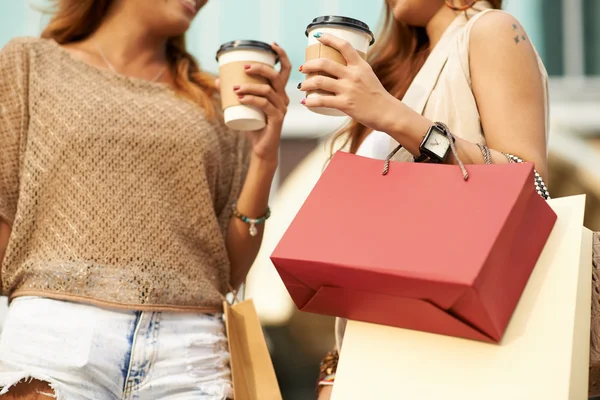 Female shopaholics chatting and drinking coffee — Stock Photo, Image