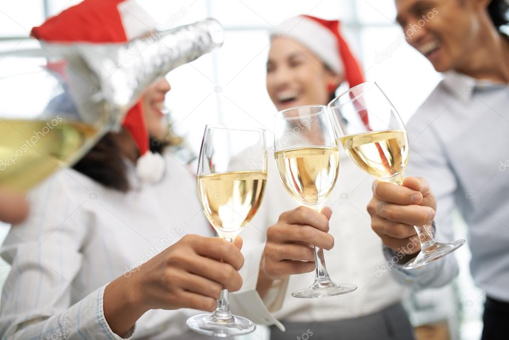Colleagues clinking glasses at Christmas party