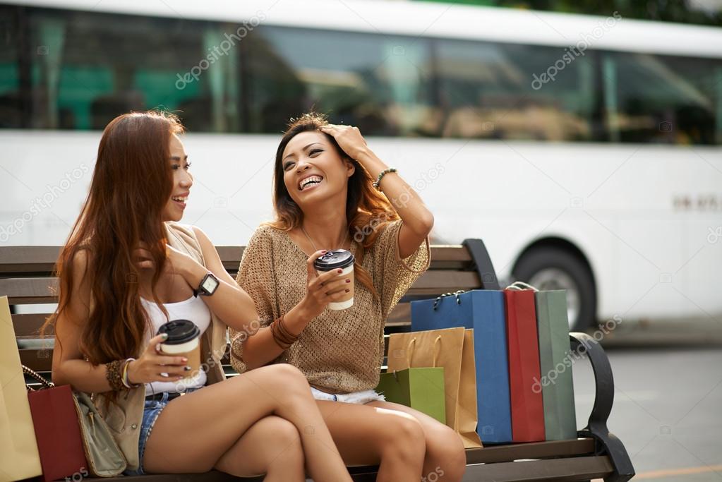 Laughing female friends resting