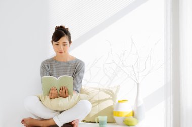 Kitap okuyan genç bir kadın