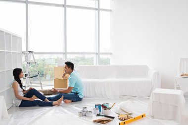 Asian couple making repairs in apartment clipart