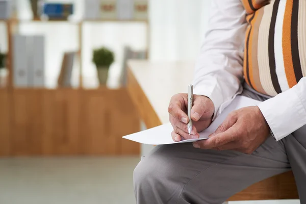 Uomo che scrive idee su un foglio di carta — Foto Stock