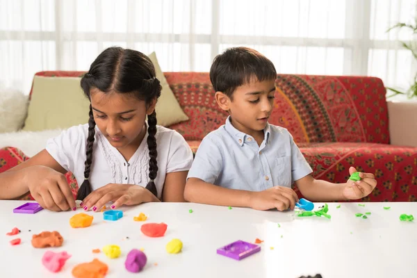 Brother and sister playing with playdough — Stock Photo, Image